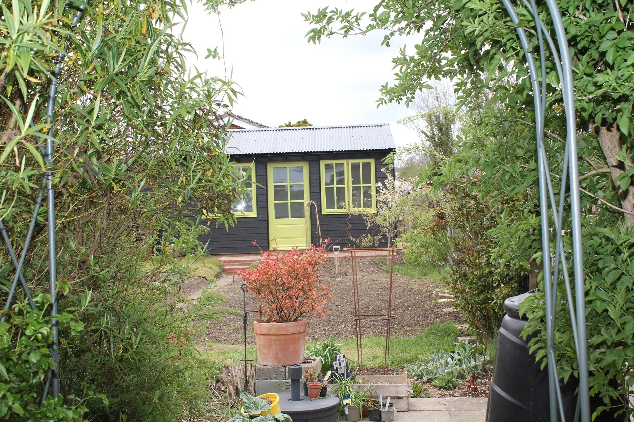a small black house with a yellow door
