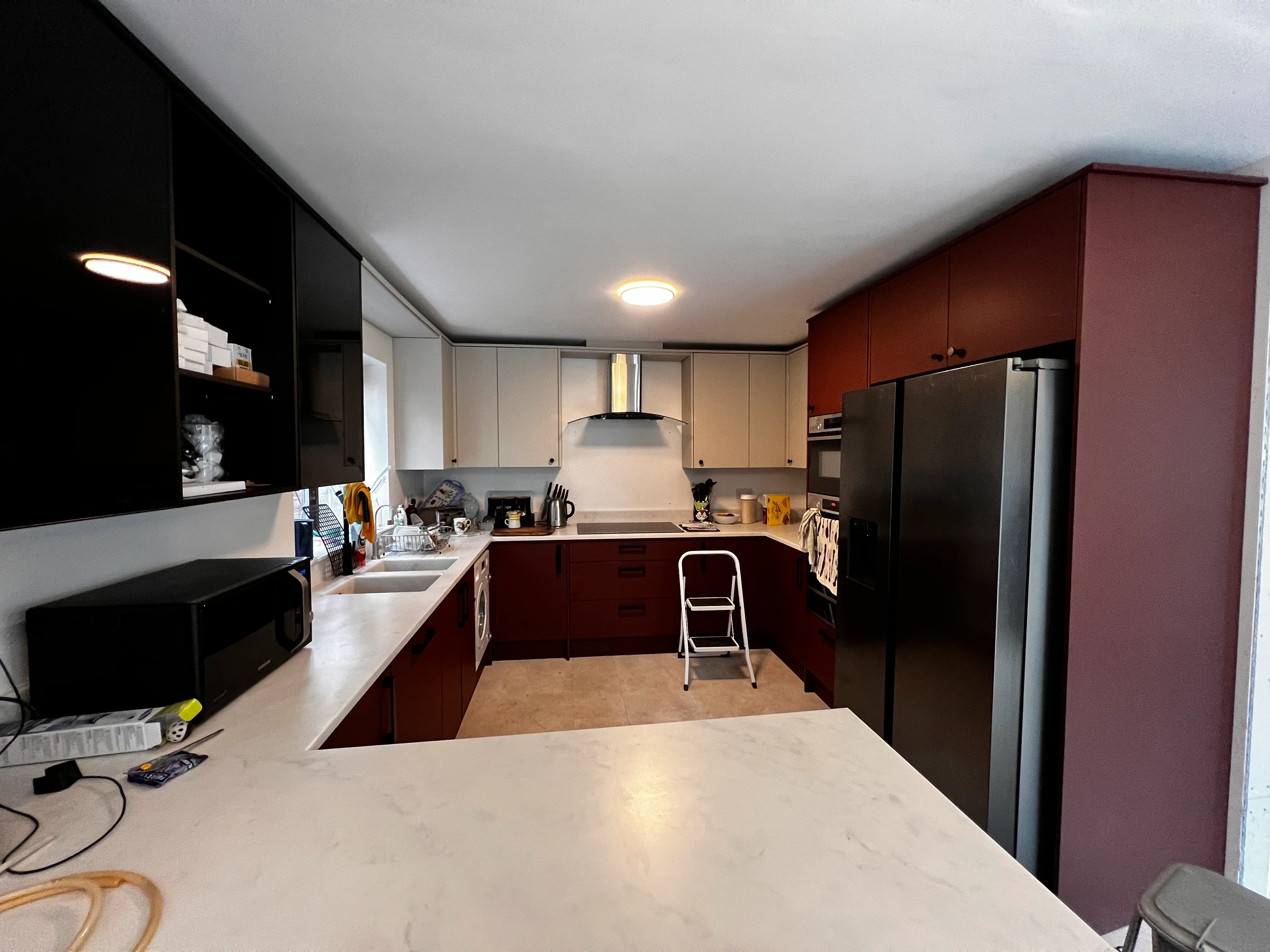 a kitchen with a refrigerator a sink and a window