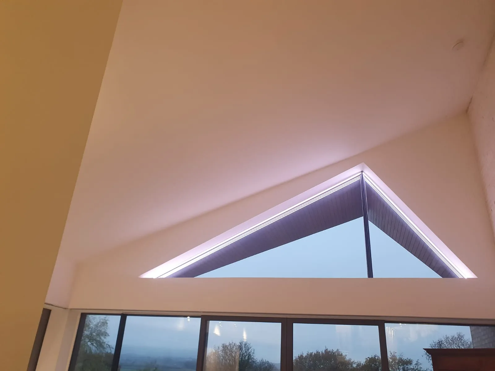 a room with a large window and a skylight