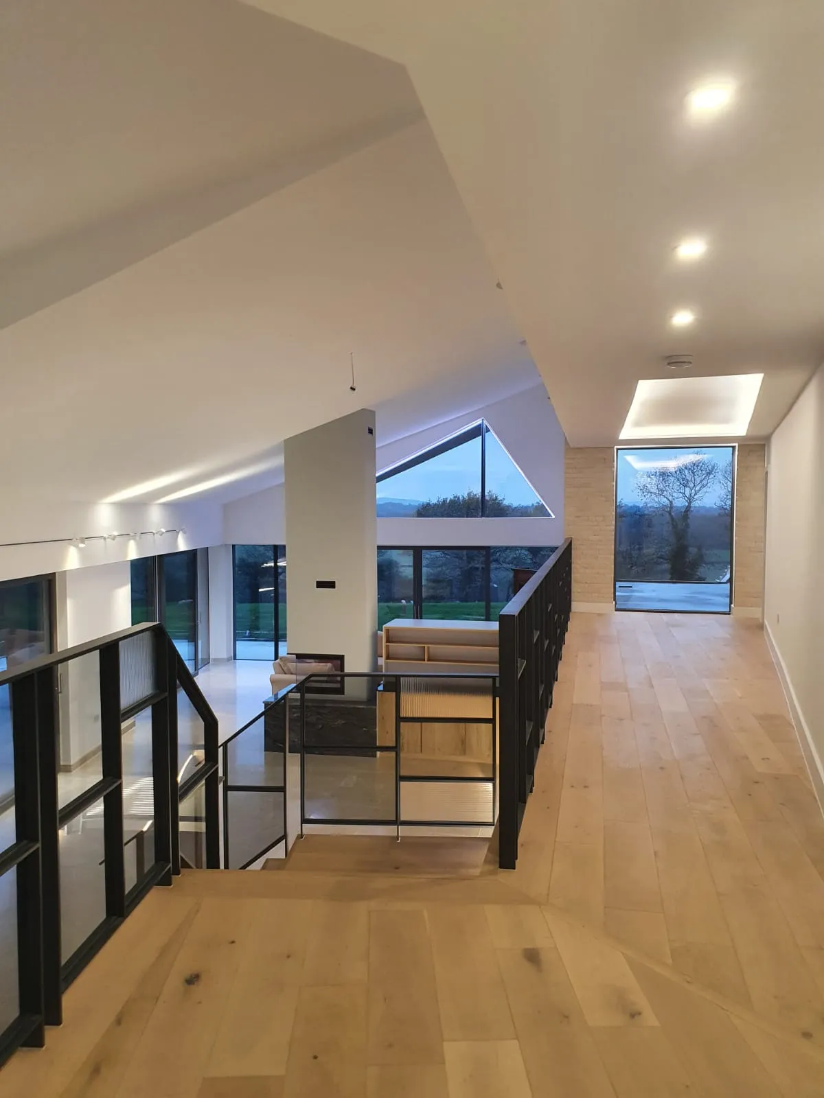 a room with a wooden floor and a staircase