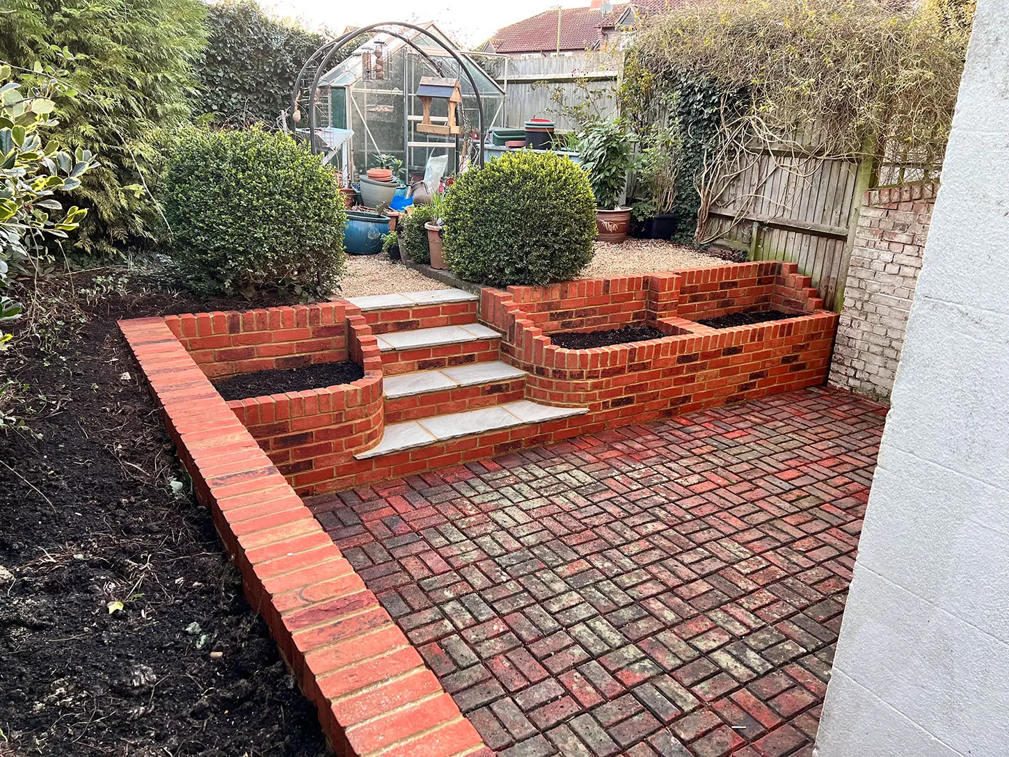 a brick patio with steps leading up to it