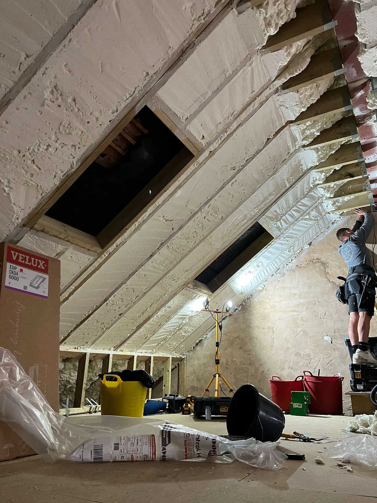 a man on a ladder working on a ceiling